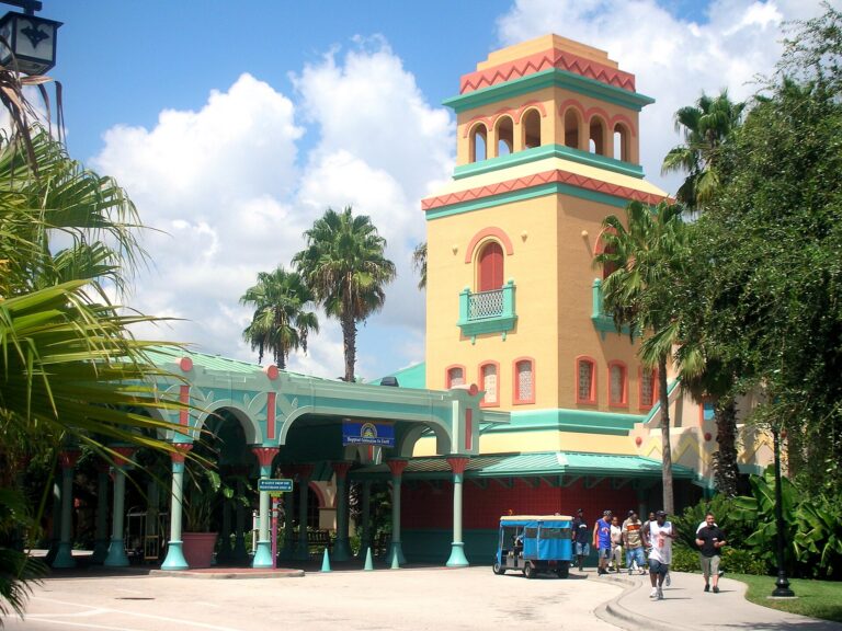 Pastel Caribbean-style resort tower framed by palm trees at Disney's Caribbean Beach Resort