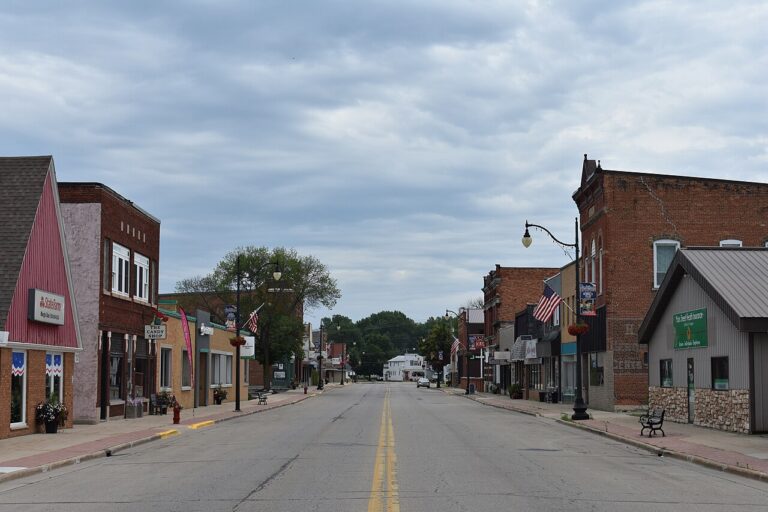 Brick storefronts lining downtown Oconto, Wisconsin, beneath an overcast sky