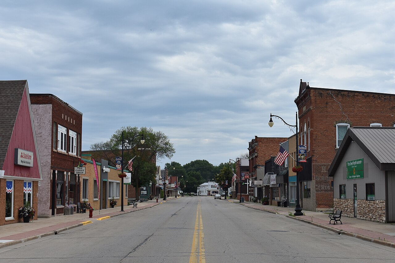 Brick storefronts lining downtown Oconto, Wisconsin, beneath an overcast sky