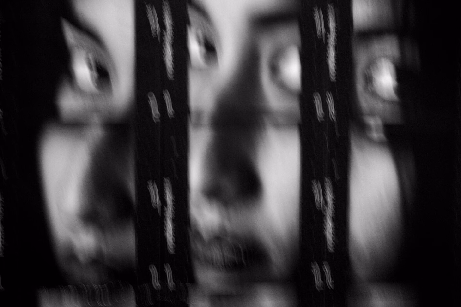 Black-and-white art photograph in which the frames of a contact print are combined into a portrait of a woman, with film-strip borders and visible grain