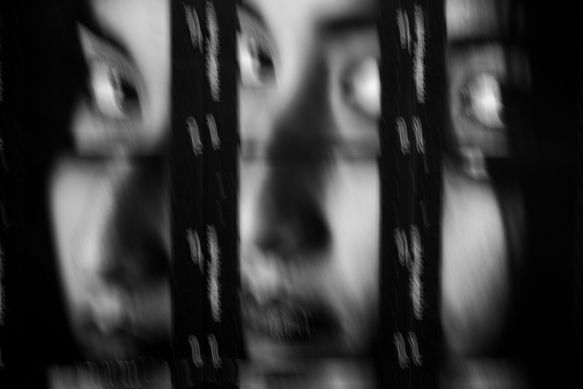 Black-and-white art photograph in which the frames of a contact print are combined into a portrait of a woman, with film-strip borders and visible grain