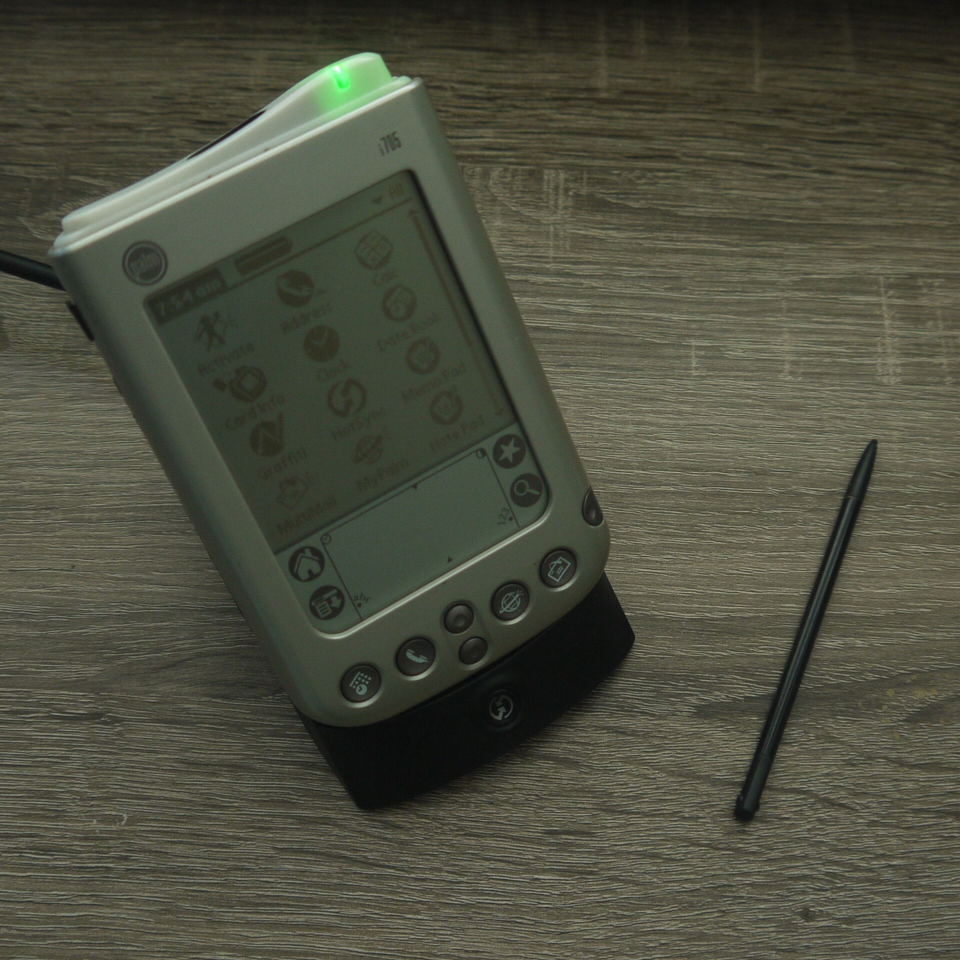 Palm i705 PDA in a docking cradle