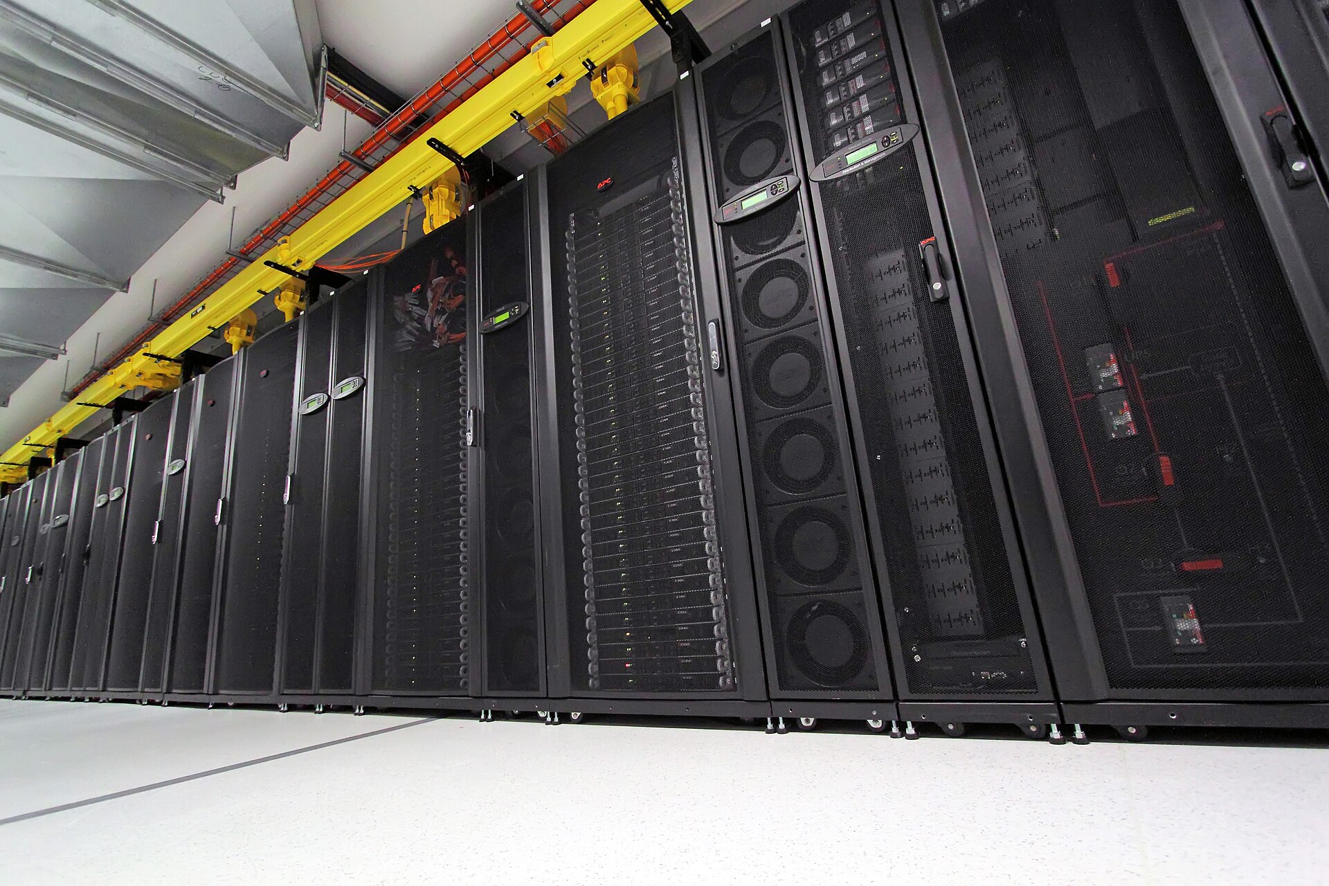 A row of computer servers housed in server racks.