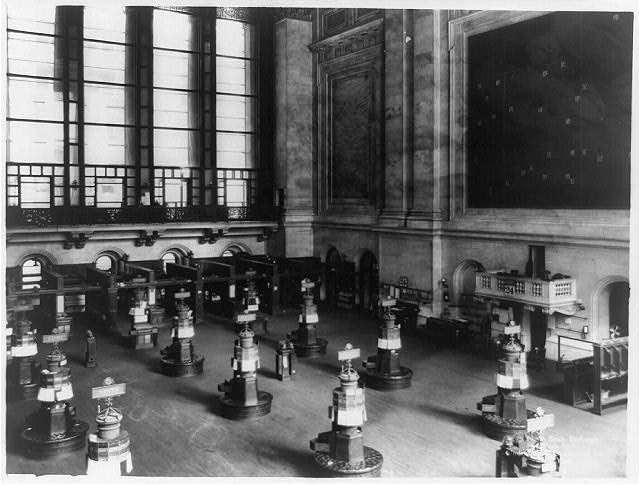 Historic black-and-white interior view of the New York Stock Exchange trading floor