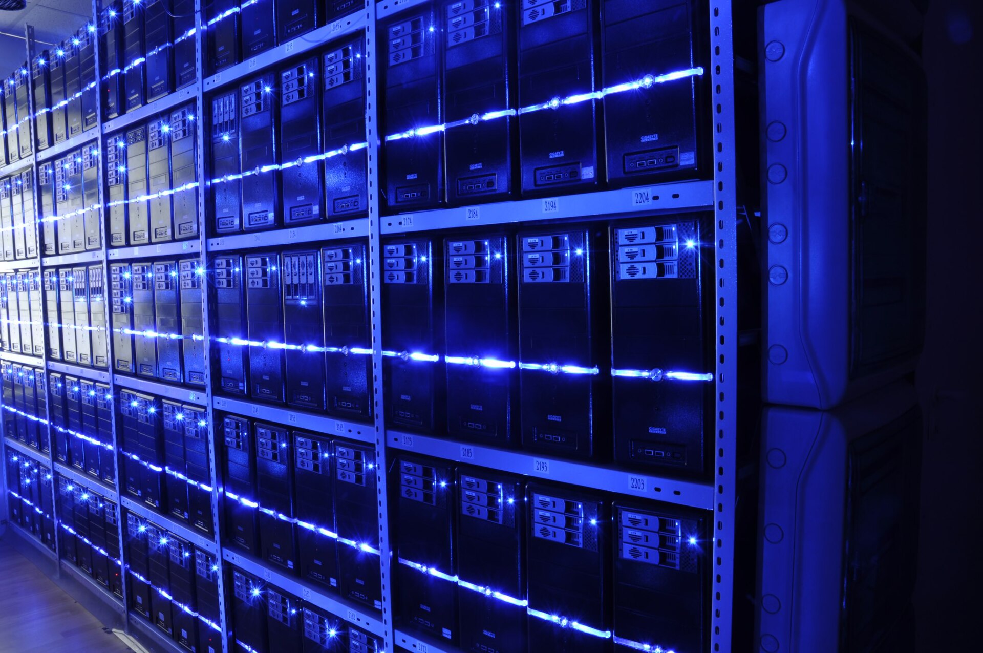 Rows of blue-lit server racks inside a data centre